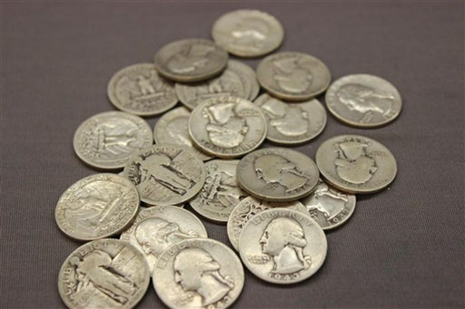 pile of pre-1965 silver standing liberty and washington quarters